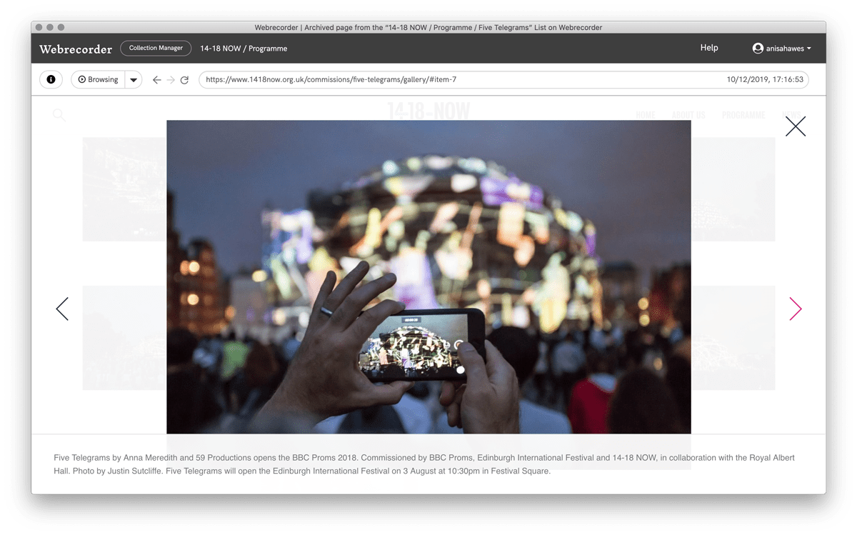 Screenshot of an archived webpage featuring an exterior, nighttime photo by Justin Sutcliffe. Background of image shows the Royal Albert Hall, London with coloured light projections onto the building. Foreground of the image shows someone's hands holding an iPhone in landscape mode to make a video and upon its screen, a picture of the scene.